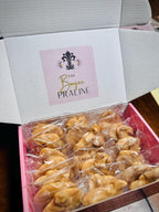 Handmade authentic New Orleans pecan pralines served fresh in signature packaging.