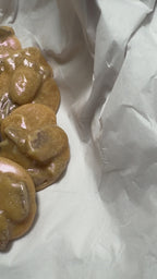 Handmaking wedding cake New Orleans pecan pralines with edible shimmer and whole pecan halves